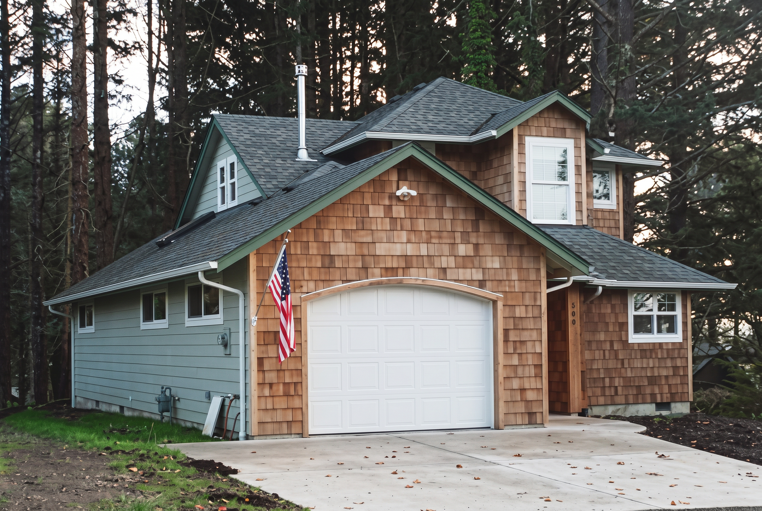 Exterior of the Lincoln City Getaway house with cedar-shingle roof and blue-gray siding